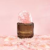 HeartStone Eau de Parfum showcased against a pink-toned water backdrop.